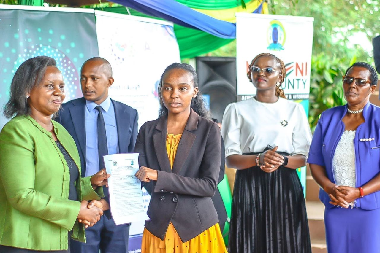 County officials handing over an internship placement letter
